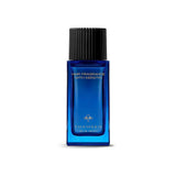 Blue rectangular glass bottle of hair fragrance with a black ridged cap and gold-toned emblem. Text reads "HAIR FRAGRANCE WIT
