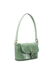side view of the BY FAR Miranda baguette bag in a light green croco-embossed leather featuring a matching shoulder strap and gold-tone buckle against a light grey background.