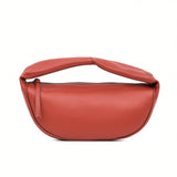 Front view of a burnt orange leather crescent shoulder bag by By Far at BLUE SALON, featuring a zippered top and a padded top handle.