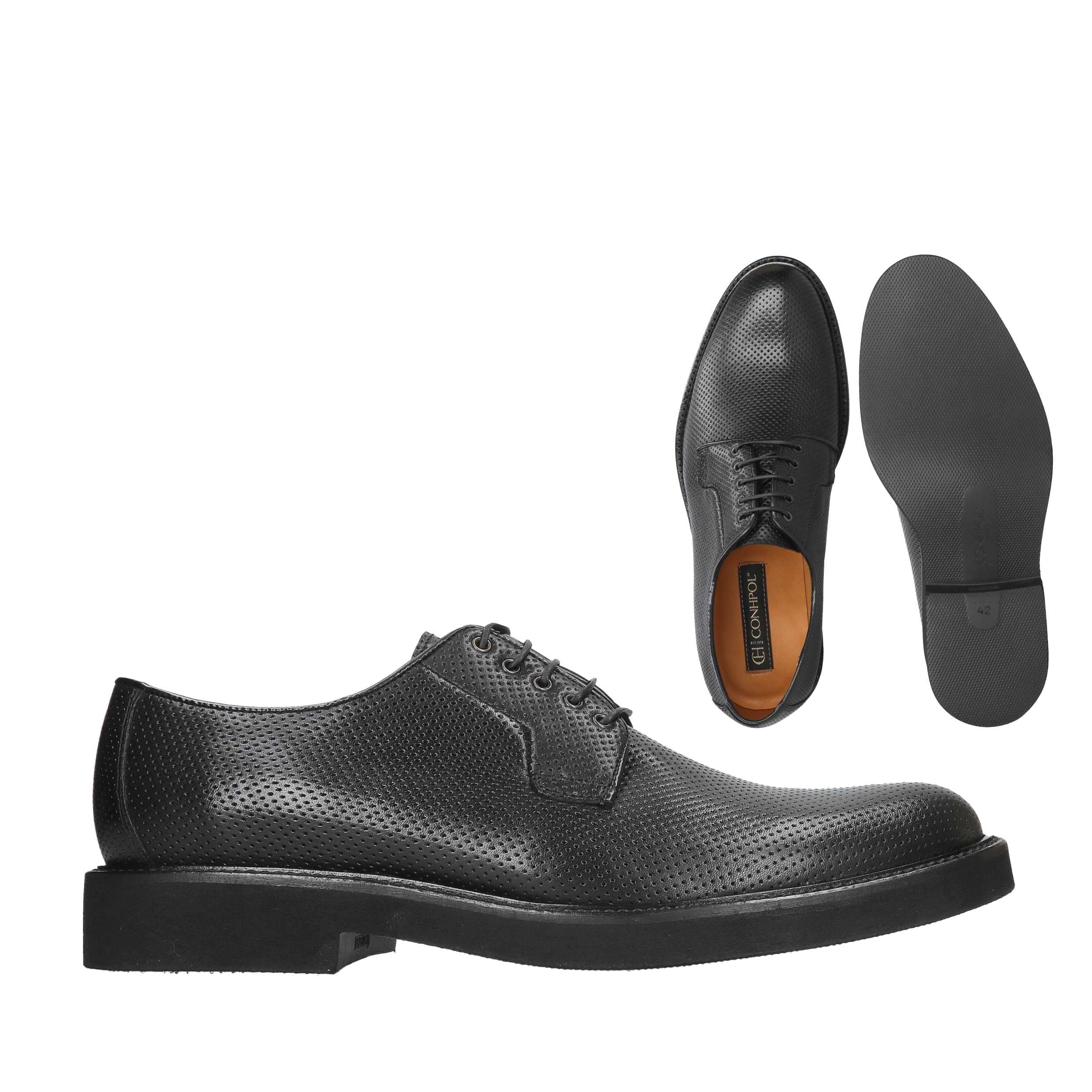 Black perforated leather lace-up derby shoes with thick black soles and a tan insole.