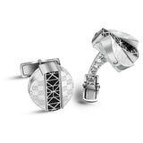 Silver-toned cufflinks with mother-of-pearl and black geometric. Round with square motifs; multi-faceted with openwork arm.