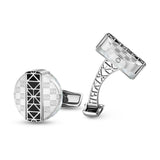 Silver-toned cufflinks with white MOP and geometric patterns. One round with black center, other rectangular with openwork ar