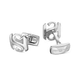 Pair of polished silver-toned cufflinks. Each features intertwined 'S' and 'H' letters. One swivel bar is engraved 'SAINT HON