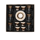 CASA BLU 13-piece luxury tea and coffee set featuring six gold-rimmed glass tea mugs with handles, six ceramic cawa cups, and one matching saucer arranged in a black foam-lined gift box.