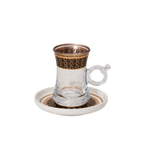CASA BLU 18-piece luxury beverage set in a black display box, featuring six clear tea glasses with gold rims, six white and gold Arabic coffee cups, and stacked gold-patterned saucers.