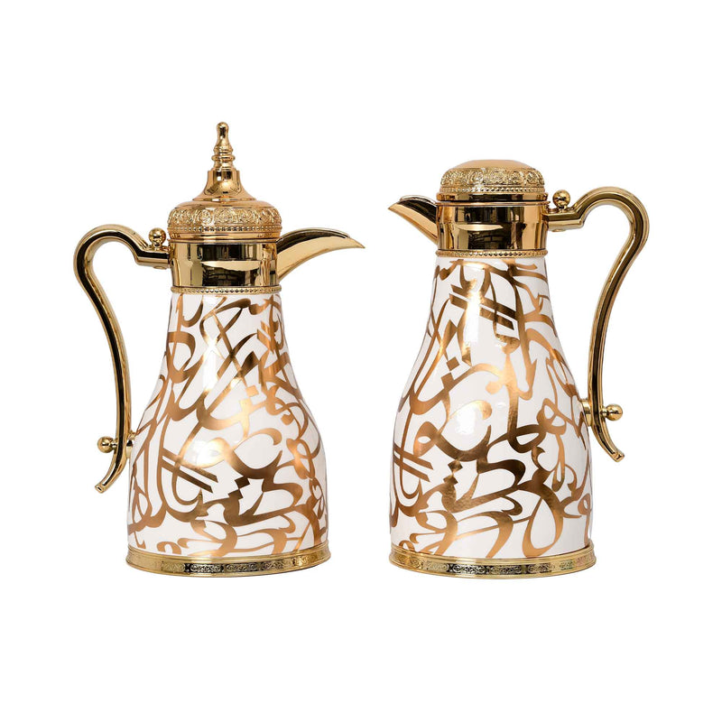 Two CASA BLU luxury Arabic thermoses with gold Arabic calligraphy patterns, pearl white finish, and ornate gold-tone handles and lids.