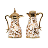 Two CASA BLU luxury Arabic thermoses with gold Arabic calligraphy patterns, pearl white finish, and ornate gold-tone handles and lids.