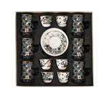 CASA BLU 13-piece tea and Arabic coffee set in a black foam-lined gift box. The set includes six glass tea cups and six porcelain coffee cups featuring a colorful green, red, and blue geometric mosaic pattern with gold accents.