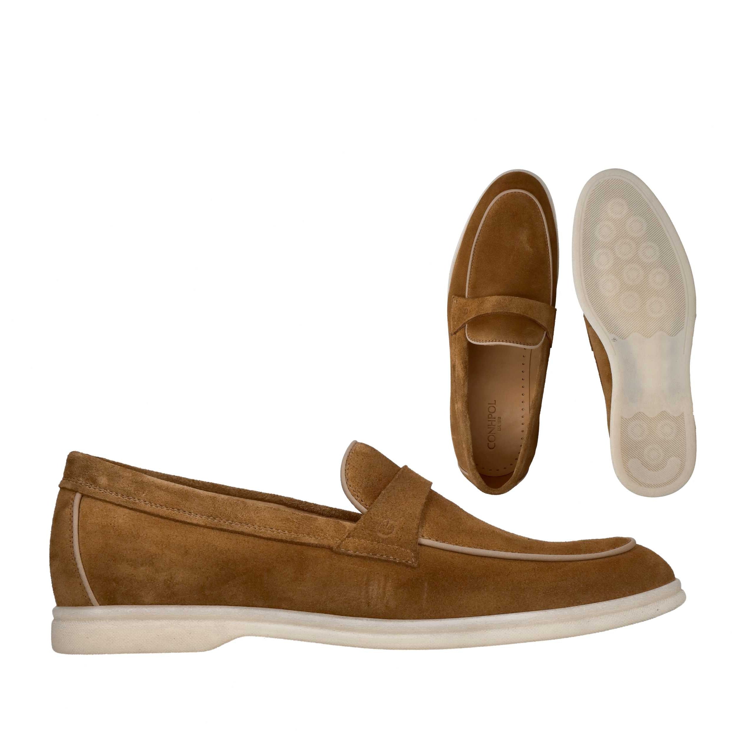 Brown suede penny loafers with light cream piping and matching soles. The sole has a textured pattern.