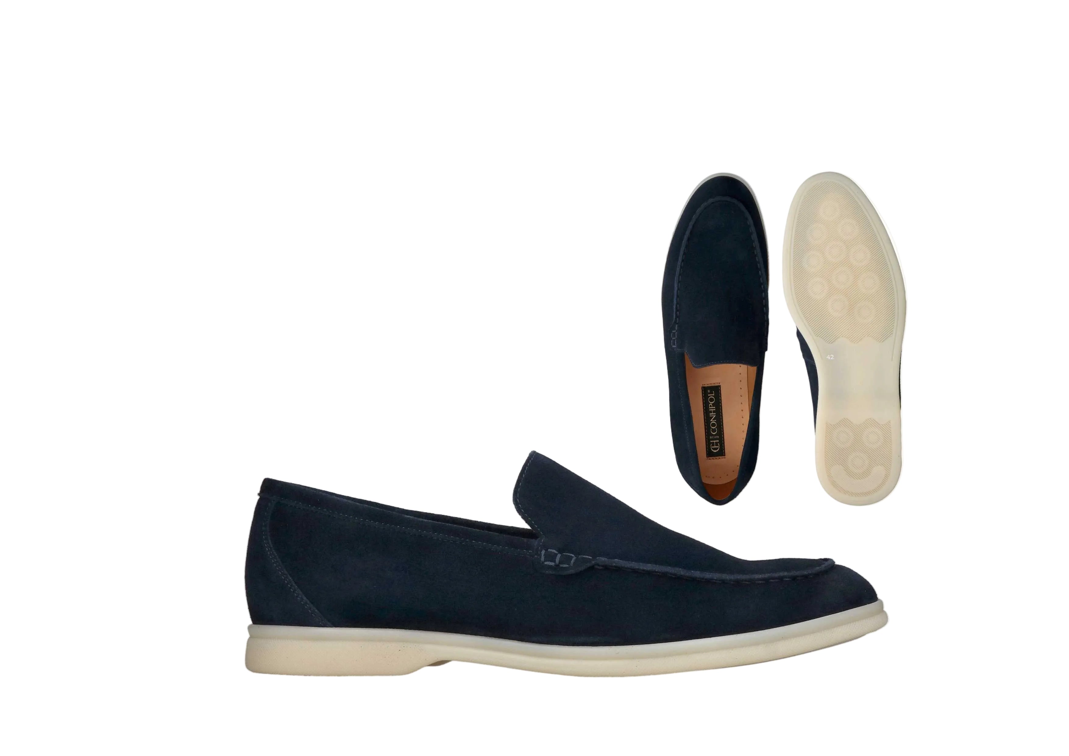 Navy blue suede loafers with moc-toe stitching, light cream soles, and a light brown inner sole with a logo.