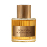 Clear ridged glass perfume bottle with gold-toned liquid, a gold-toned ridged cap, and a gold label with 'TOM FORD BOIS PACIF