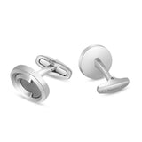 Pair of silver-toned cufflinks. One has a circular face with a dark logo; the other shows a plain back and "CERRUTI 1881" eng