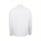 White long-sleeved shirt with a textured fabric, standard collar, shoulder yoke, buttoned cuffs, and a curved hem, viewed fro