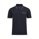 Navy blue short-sleeved men's polo shirt with a white collar and light beige trim on the collar edge, placket, pocket, and cu