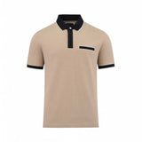 Light beige short-sleeve polo shirt with black collar, placket, and cuffs, all featuring white trim. Has a black-trimmed ches