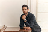 Round silver-toned watch with a dark bezel, bright blue chronograph dial, and a silver-toned metal link bracelet.