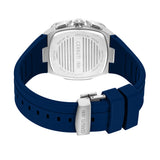Silver-toned square watch case back with engraved text, attached to a dark blue silicone strap with a silver-toned deployant