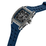 Silver-toned tonneau watch with a blue silicone strap. The blue dial features a textured black center, white markers, and two