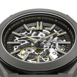 Gunmetal watch with skeletonized black dial. Silver-toned hands and markers with gold-toned details, revealing internal gears