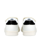Back view of white low-cut sneakers with black heel tabs, off-white soles, and white velcro straps.