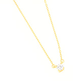 Gold-toned delicate link chain necklace with a single round, clear zircon stone in a four-prong setting.