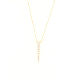 Delicate gold-toned chain necklace with a vertical, tapered pendant featuring a row of graduated clear stones.
