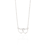 Silver-toned necklace featuring two interlocking heart pendants on a delicate chain with a polished finish.