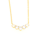Gold-toned delicate chain necklace with five clear round faceted stones set in a curved bar.