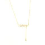 Gold-toned delicate chain necklace with a central cluster of clear star-shaped faceted stones and a drop chain with a single