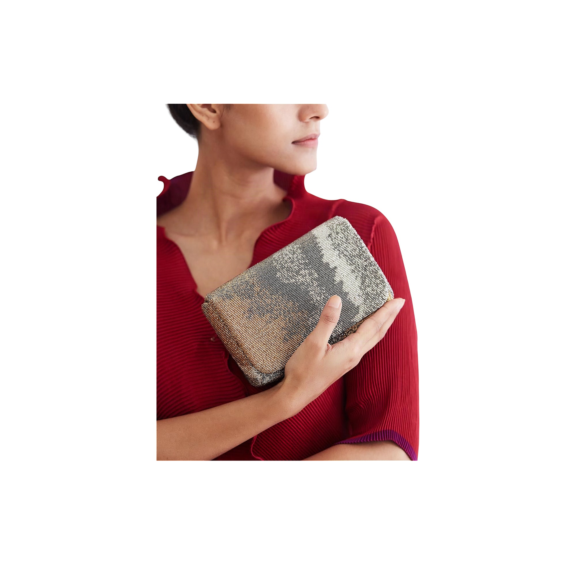 Flapover clutch with a beaded surface, featuring an abstract pattern of lustrous silver-toned and gold-toned beads.