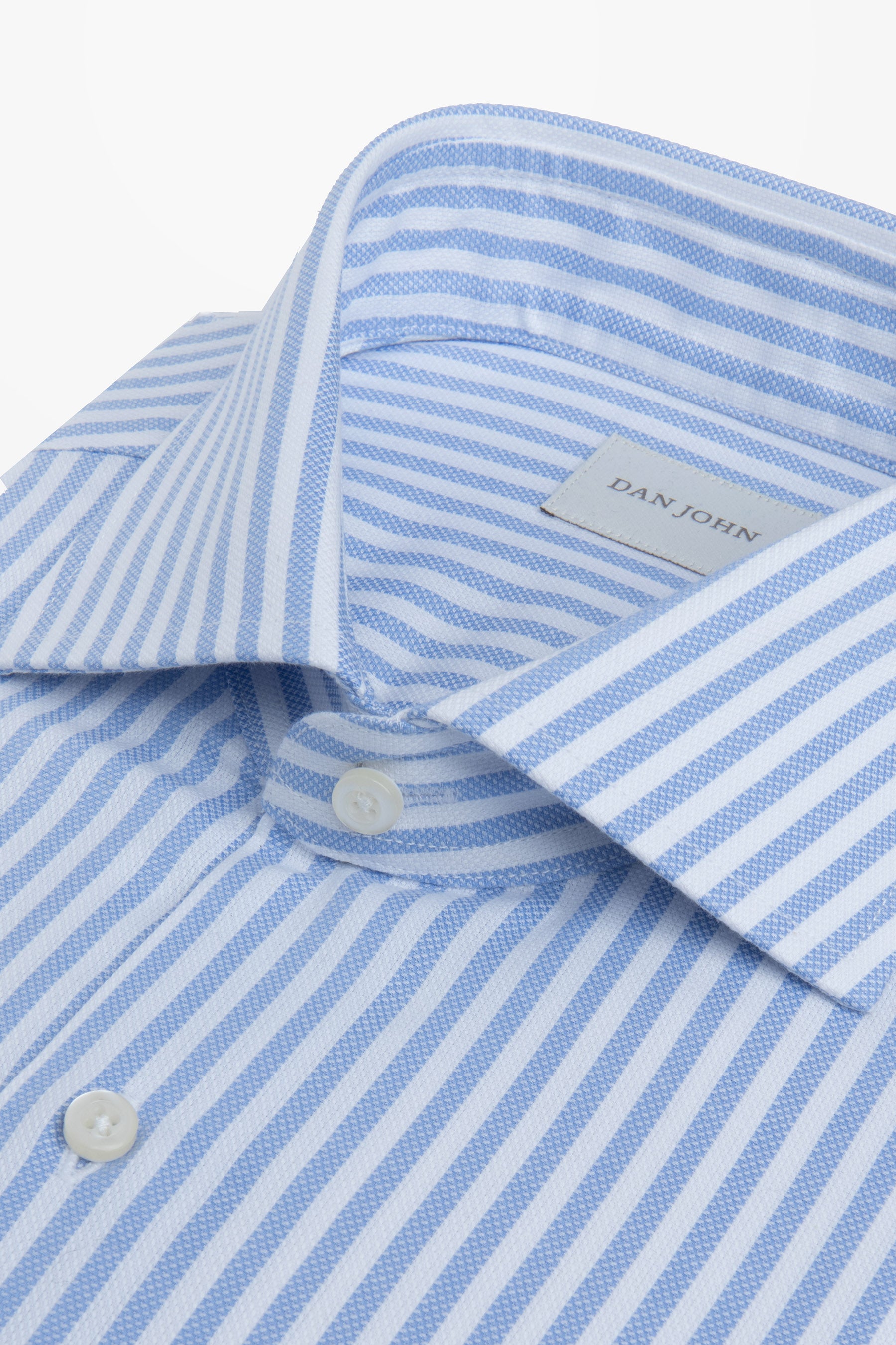 Light blue and white striped shirt with a spread collar and white buttons. Blue stripes feature a textured weave.