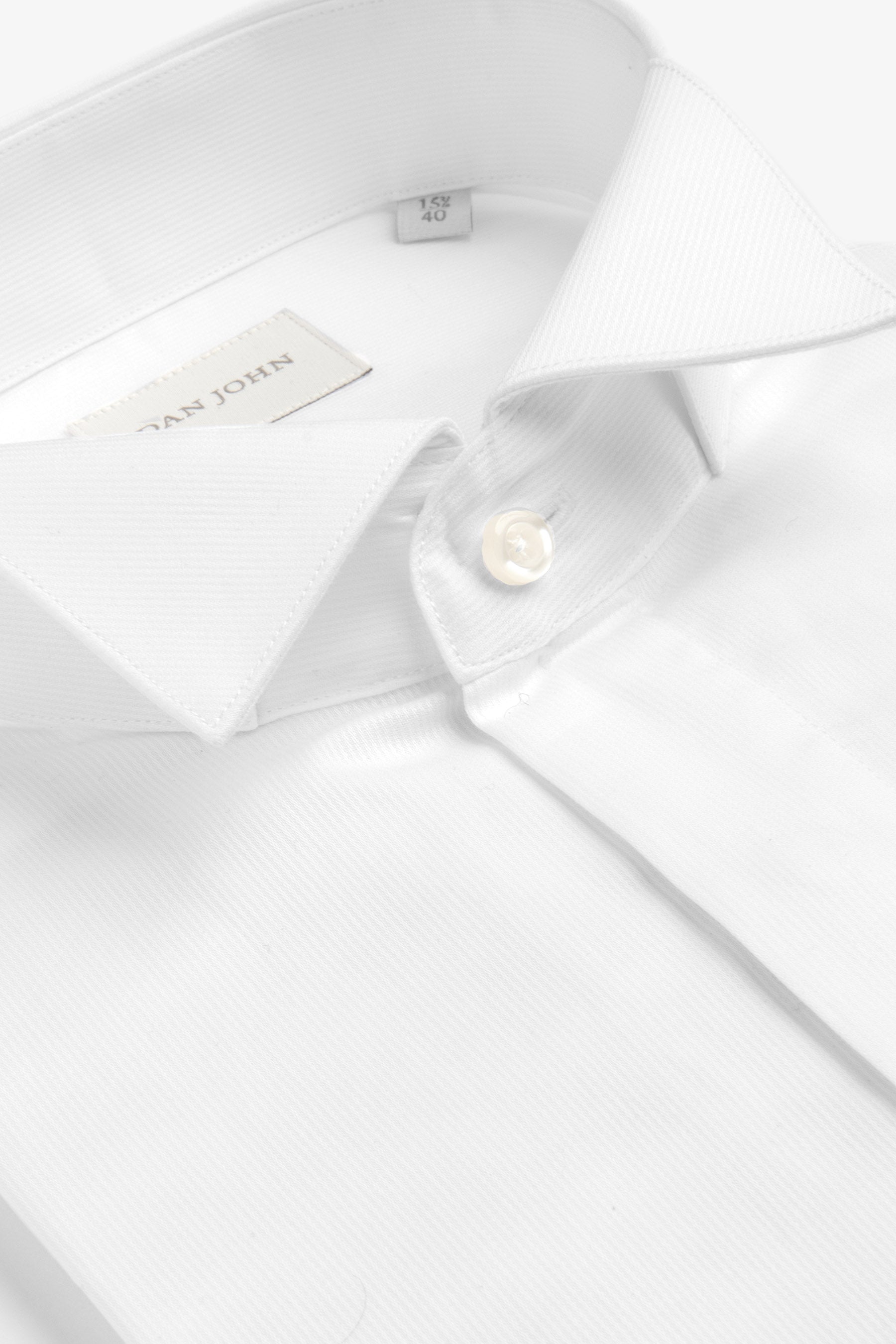 White fine-ribbed shirt with a classic pointed collar, one visible mother-of-pearl button on the collar stand, and a brand la
