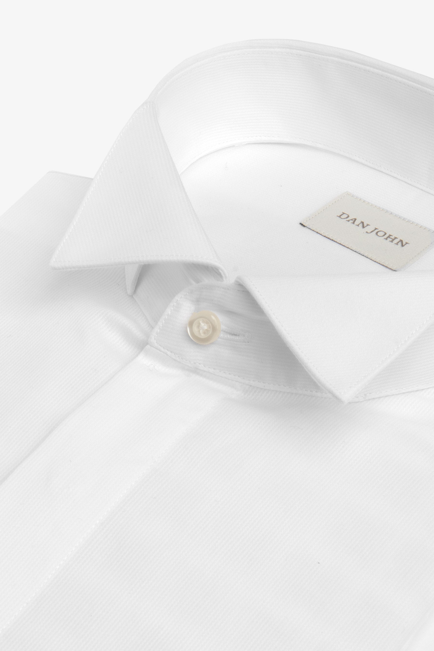 White dress shirt with a classic pointed collar and a single light button. Features a subtle vertical ribbed texture.