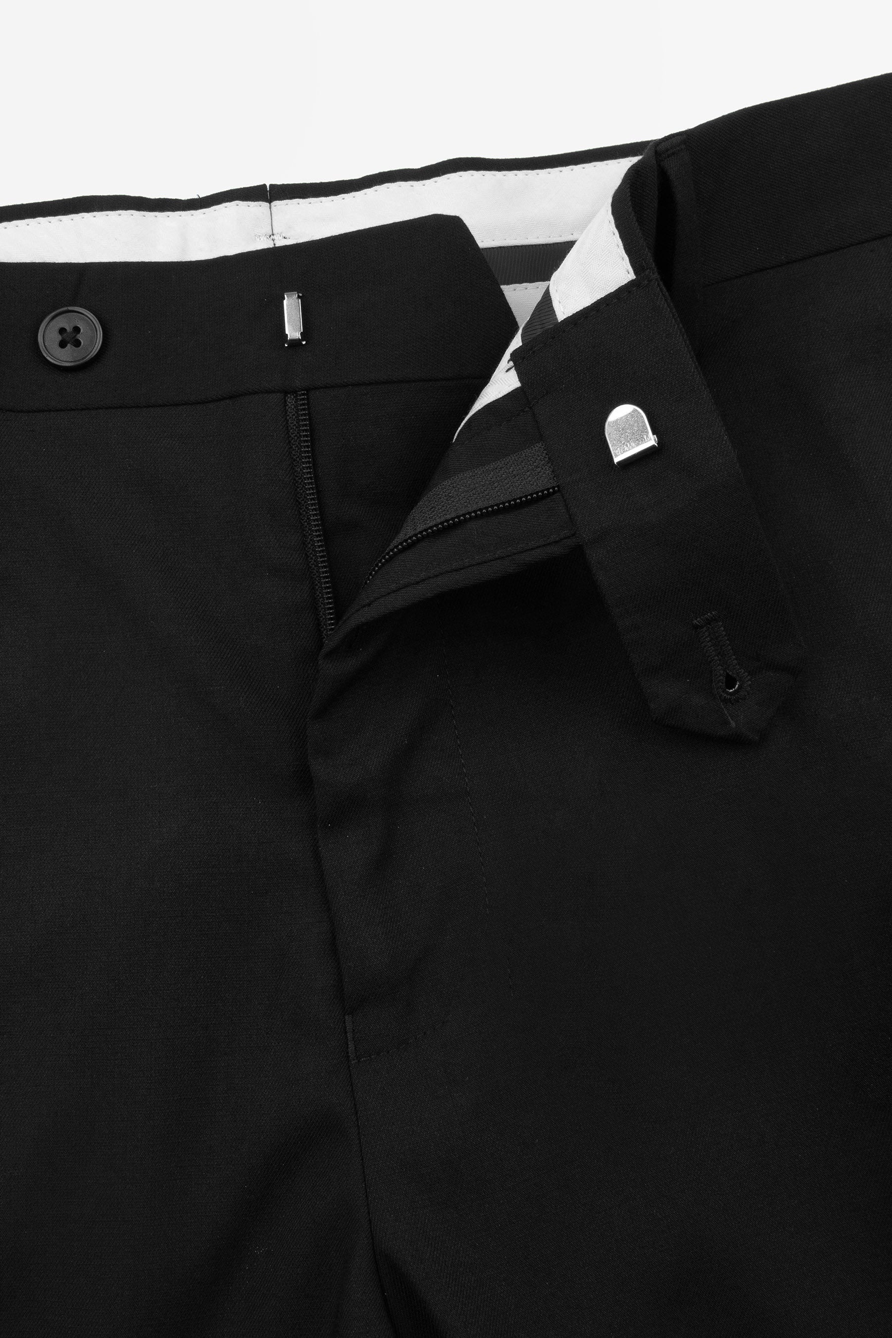 Black modular pants with a striped inner waistband. Features a black button, silver-toned hook-and-bar, and D-ring clasp.