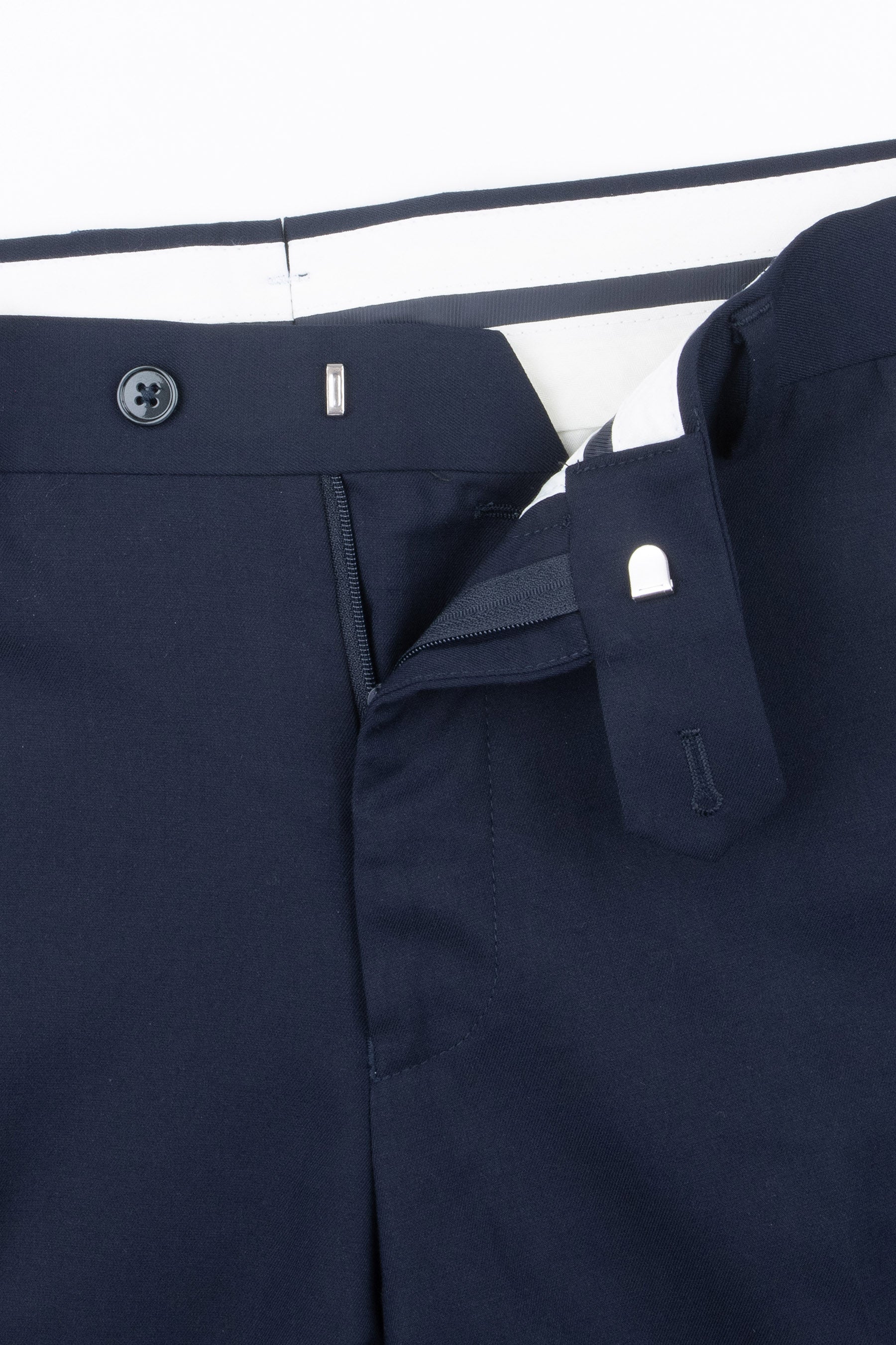 Navy blue modular pants with a partially unzipped fly, a button, and silver-toned hook-and-bar waistband closures.
