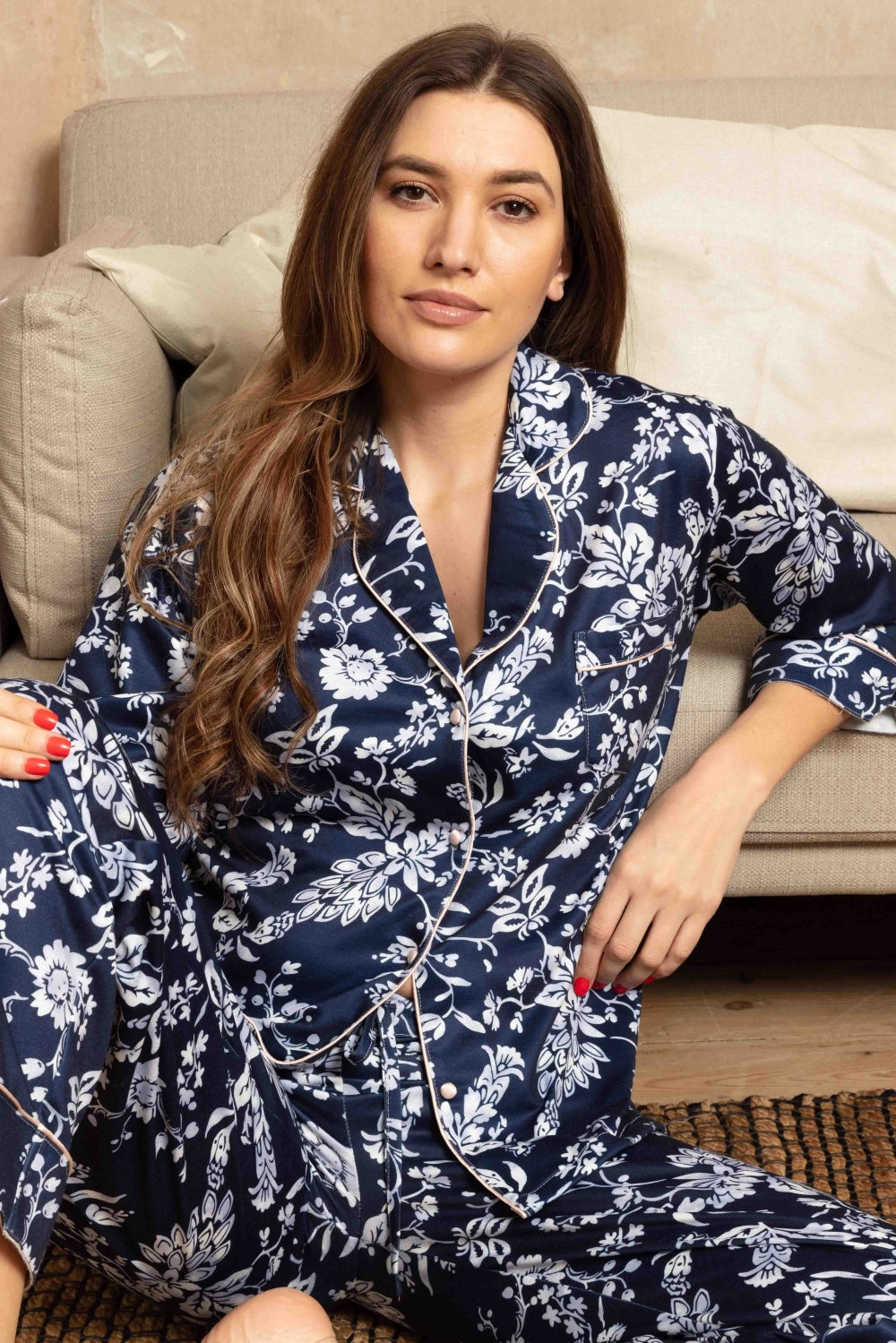 Midnight blue long-sleeved pajama set with white floral pattern. Smooth fabric, light pink piping on collar, placket, cuffs,