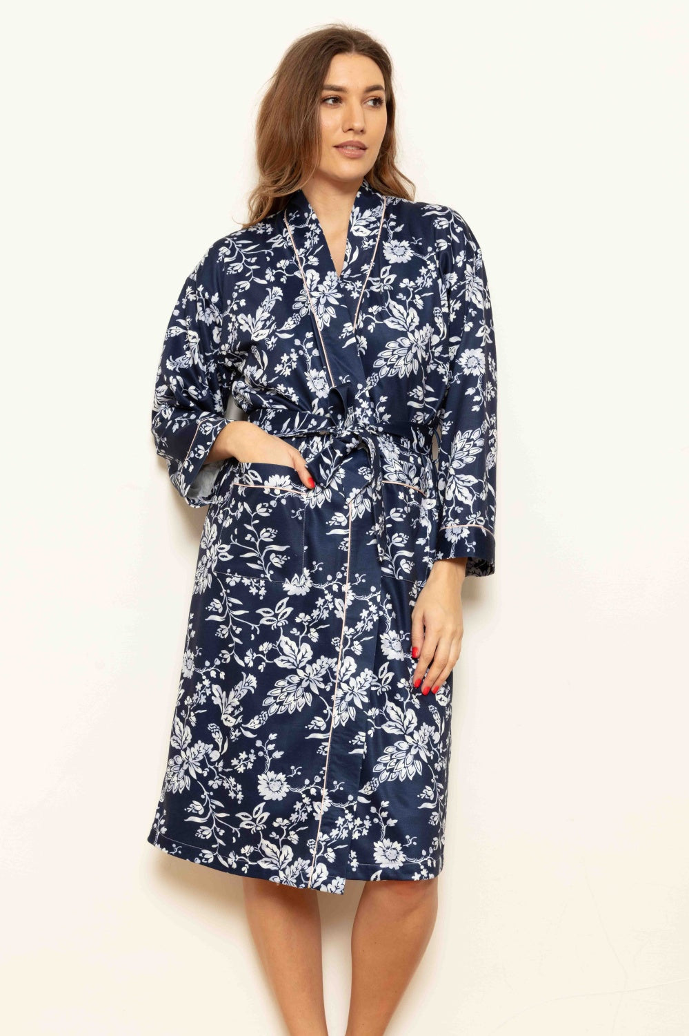 Midnight blue cottonfleece kimono wrapover robe with white floral pattern, V-neck, tie belt, two pockets, and pink piping.