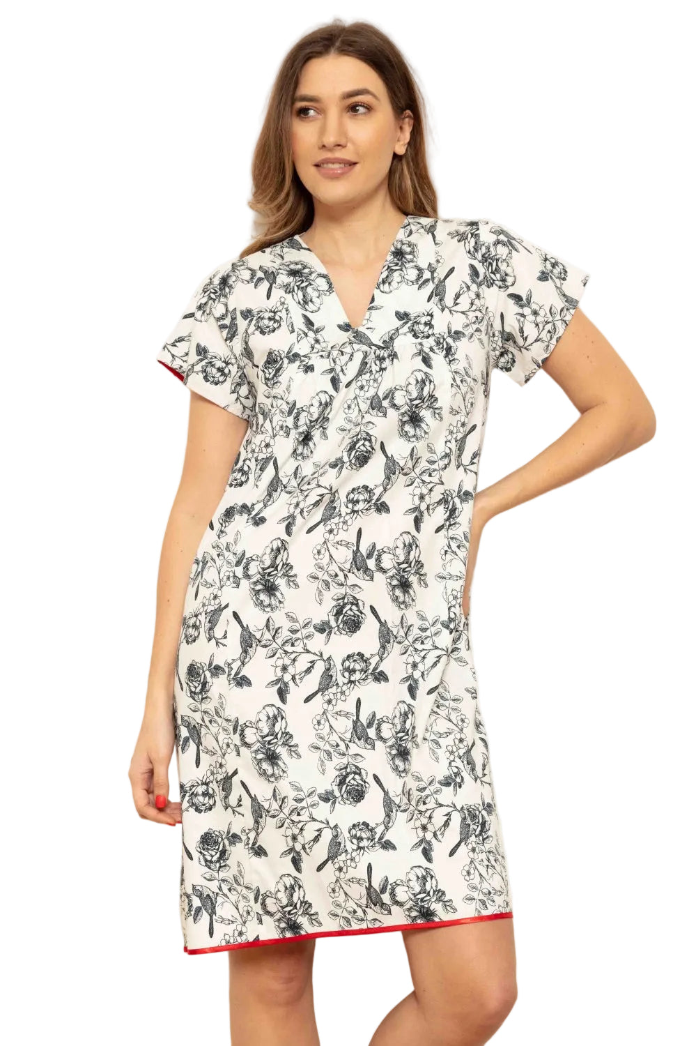 White cap sleeve V-neck dress with black botanical and bird pattern and red trim on sleeves and hem.