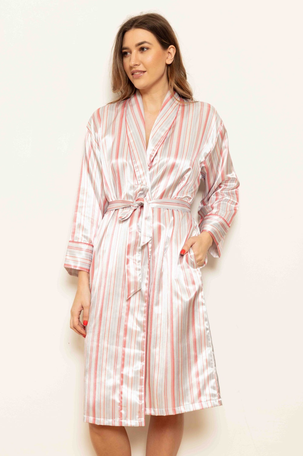 Shiny white knee-length robe with coral and gray candystripes, a shawl collar, self-tie belt, and two front pockets.