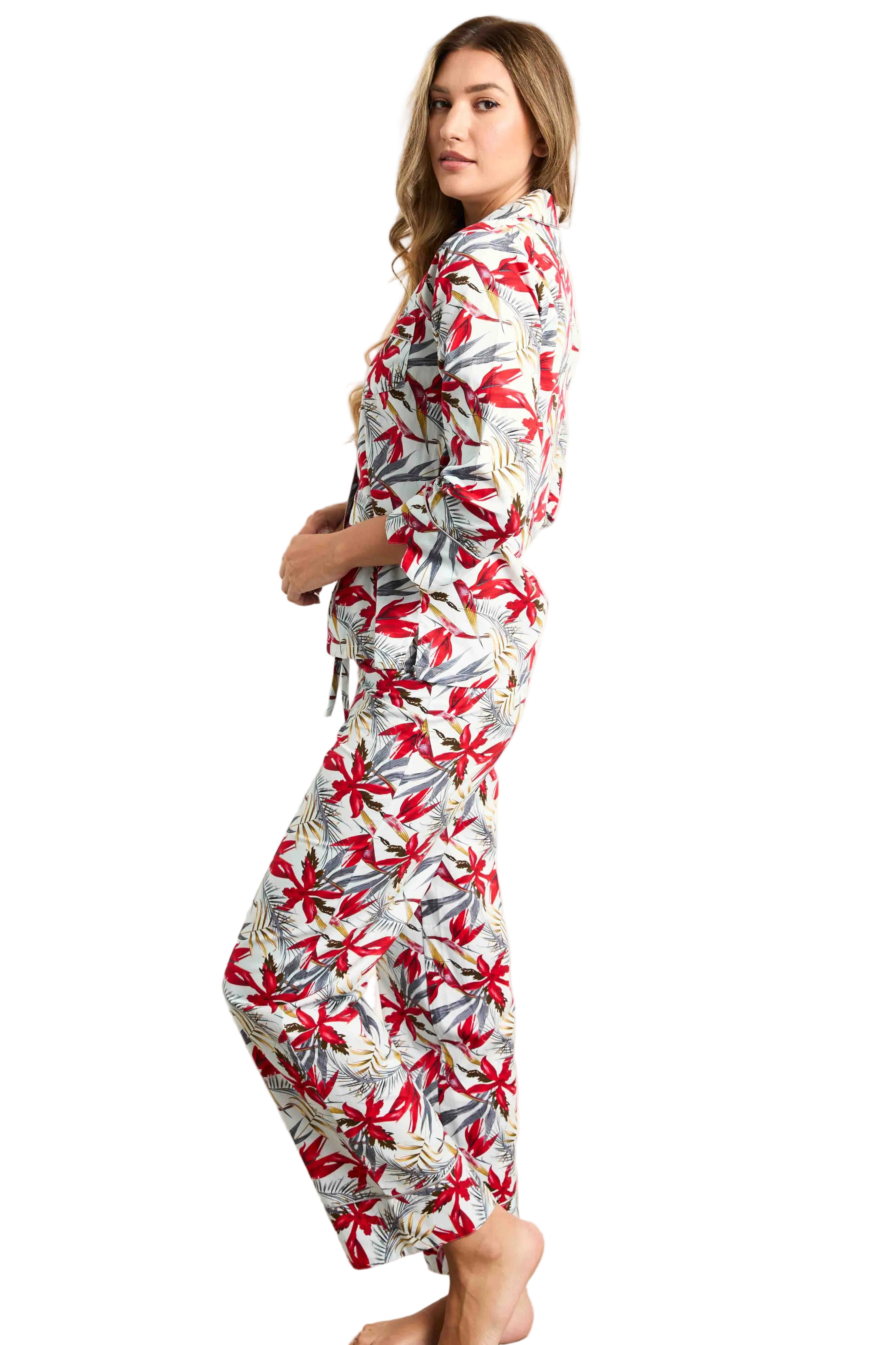 White pyjama set with red and grey birds of paradise floral pattern, featuring a collared shirt and trousers.