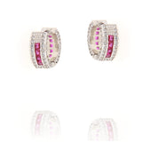 Pair of silver-toned hoop earrings with a central row of square pink stones, flanked by clear paved stones. Inner hoop has pi