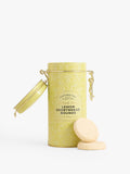 Yellow tin of lemon shortbread rounds with a couple of cookies 