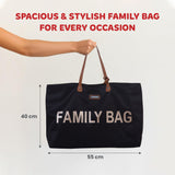 Black fabric tote bag with brown faux leather straps attached by gold-toned rivets. Features "CHILDHOME" label and large gold
