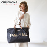 Black fabric tote bag with brown handles, gold-toned rivets, and "FAMILY BAG" in large gold-toned letters on the front.