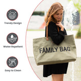 Large khaki canvas tote bag with 'FAMILY BAG' printed in black, featuring brown leather-look shoulder straps attached with go
