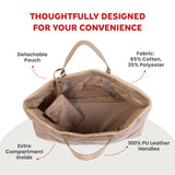 Beige quilted changing bag with two beige PU leather handles and a matching detachable pouch inside.