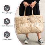 Puffy beige quilted tote bag with 'FAMILY BAG' embroidered on the front, featuring light brown top handles and silver-toned h