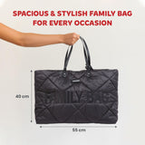 Black quilted puffer tote bag with 'FAMILY BAG' embossed on the front and black faux leather handles.