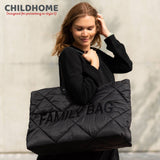 Large black puffed changing bag with diamond quilting. 'FAMILY BAG' text on front, black shoulder straps.