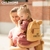 Beige teddy kids backpack with bear ears, a front zip pocket with brown pull tab, and 'MY FIRST BA' text.